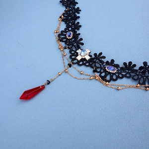 Gothic black lace choker with blue gemstone cross and red teardrop crystal pendant