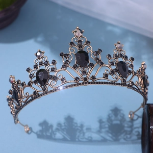 Close-up of vintage black rhinestone bridal crown with gold alloy filigree vine details