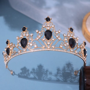 Detail of vintage gold crown with black teardrop gems and sparkling rhinestones