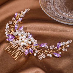 Macro shot of handmade gold wire hair comb with white pearls and purple crystals