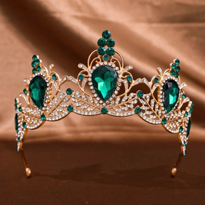Detail view of Baroque crown with gold filigree and large emerald green teardrop gemstones