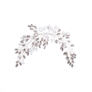 Handmade bridal crystal headband with silver wire and white pearls on a white background