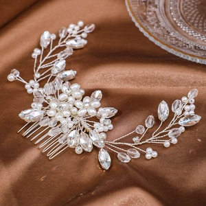 Detail of bridal hair comb with pearls and marquise crystals on brown silk background
