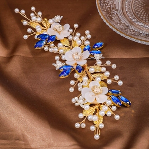 Elegant bridal hair band with gold wire flowers, blue gems, and white pearls