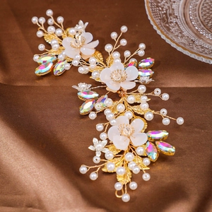 Close-up of handmade bridal headband featuring white resin flowers and crystals