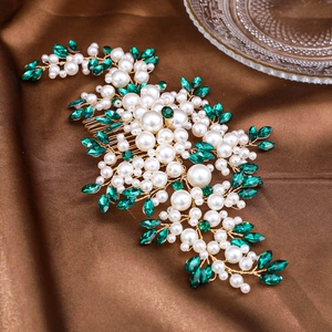Elegant bridal hair comb with pearls and emerald rhinestones on golden floral frame