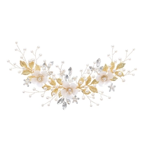 Handmade bridal hairpiece featuring white flowers with pearls and gold leaf accents