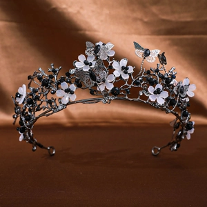 Close-up of gothic bridal crown featuring hollow butterflies and white resin flowers