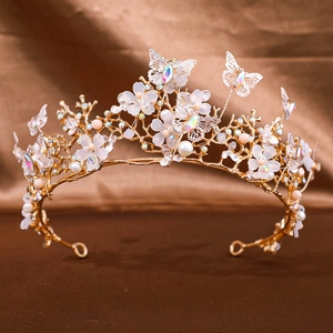 Detail of bridal gold crown with butterfly, matte flowers, and crystals on brown silk