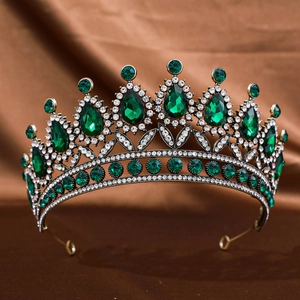 Detail of vintage crown featuring emerald green rhinestones and small white crystal pavé