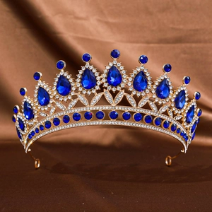 Detailed macro view of gold alloy tiara with pear-shaped blue crystals on brown silk