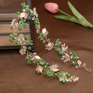 Elegant gold leaf bridal headband with green crystals and forest vine design for weddings