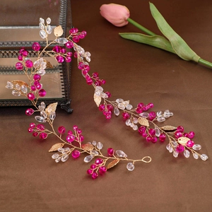 Elegant bridal hair vine with fuchsia crystals and gold metal leaves for wedding hair styling