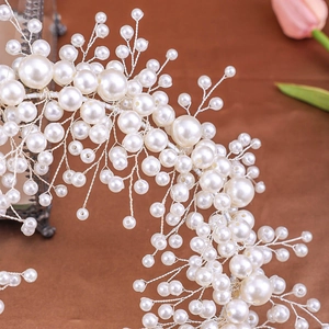 Handmade bridal headband with white faux pearls and silver wire in a floral branch design