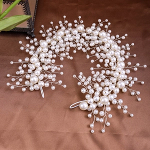Detailed view of handmade faux pearl bridal headband with intricate silver wire weaving