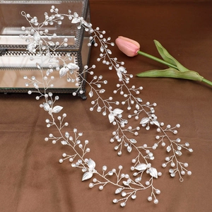 Détail de vigne de cheveux de mariée avec perles blanches et feuilles en métal argenté