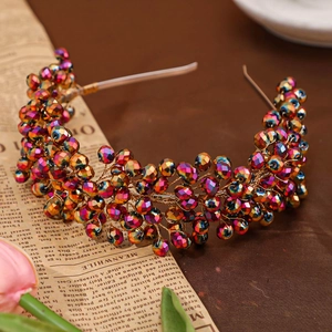 Close-up of handmade bridal headband with colorful iridescent crystal beads on golden wire