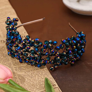 Detailed top view of handmade blue iridescent crystal headband on a vintage cloth background