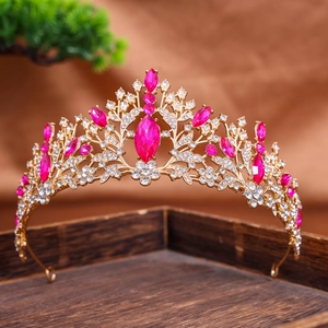 Elegant gold bridal crown with pink marquise gemstone and white rhinestones