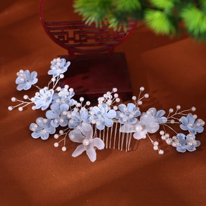 Detailed bridal hair comb with light blue silk flowers, white pearls and delicate mesh wings
