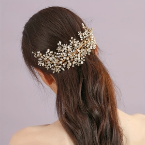 Detailed view of handmade bridal hair comb with rhinestones on an elegant hairstyle