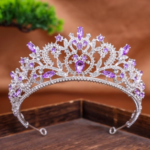 Close-up of silver baroque tiara featuring purple and clear crystals in heart and marquise cuts