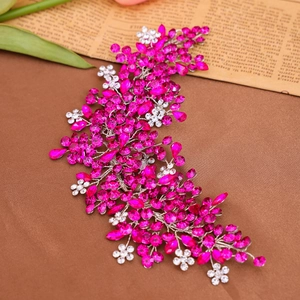 Detailed view of silver wire vine bridal hair comb with vibrant pink crystals and rhinestones