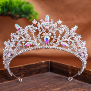 Baroque silver bridal crown with AB rhinestones and crystal teardrops on a wooden tray