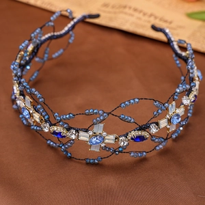 Detail of handcrafted blue crystal crown headband with woven beads and elegant mesh texture
