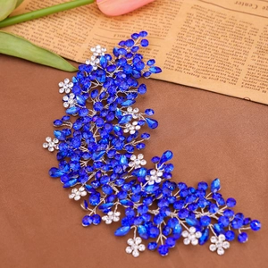Macro detail of handmade silver bridal hair comb with deep blue rhinestones and floral gems