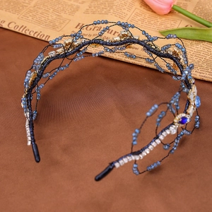 Detailed shot of retro braided headband with blue beads, silver rhinestones and gold stars