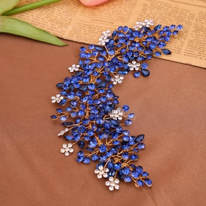 Handmade bridal hair comb with blue rhinestones and white flowers on gold wire