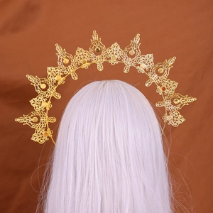 Detailed view of golden halo crown with intricate filigree on long white hair