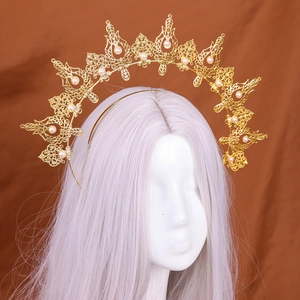 Detailed close-up of golden crown headband featuring hollow patterns and white pearls