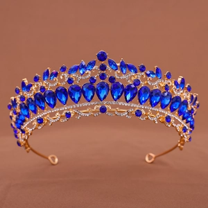 Detailed view of bridal crown featuring deep blue teardrop gems and gold alloy base