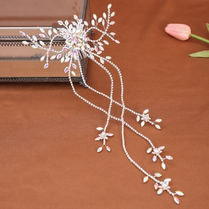 Detail of silver bridal hair comb with iridescent rhinestones and long tassels