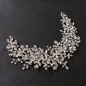 Luxurious bridal headband with silver wire vines and crystal flowers on black background