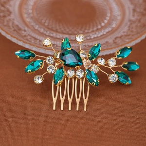 Peigne à cheveux de mariée avec cristaux vert émeraude et finition dorée sur tissu brun