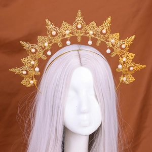 Golden baroque sunburst halo crown with intricate filigree and hanging white pearls