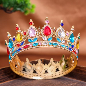 Detailed macro view of vintage golden crown with colorful gemstones and hollow patterns