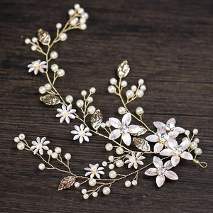 Handmade gold leaf bridal headpiece with white flowers and pearls for wedding hairstyles