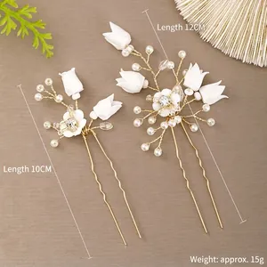 Elegant bridal hair comb set with white flowers and pearls on golden wire pins