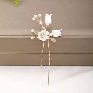 Detail of handmade lily of the valley hair pin with ceramic flowers and pearls
