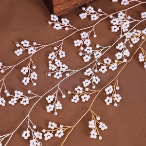 Detail of twisted bridal hair vine with small white pearls in gold and silver finish