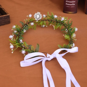 Detail of floral forest-style headband with white flowers and green fern leaves