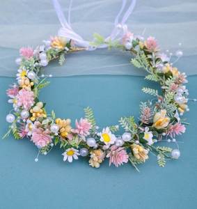 Detailed view of handmade bridal floral headband with pink daisies, leaves and pearls