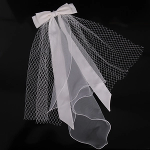 Elegant white double-layered wedding veil with a bow and rhinestones on black background