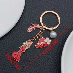 Detail of red enamel dress lady keychain with high heels and pearl charm, length 9.3cm