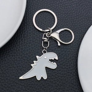 Cartoon white T-Rex dinosaur keychain with silver alloy frame and white enamel fill