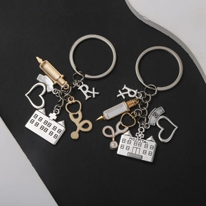 Detailed macro view of medical charms keychain featuring hospital building and stethoscope